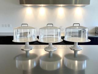 Heavy-duty cake display stands with covers, great condition, white bases, clear domes, set of 3.