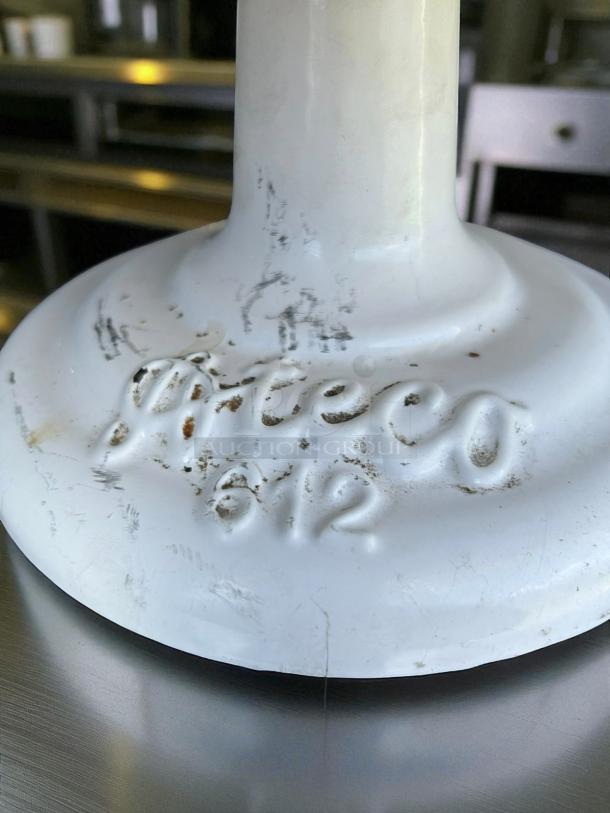 Heavy-duty cake display stand base with embossed "Piteco 612" marking, showing some wear.