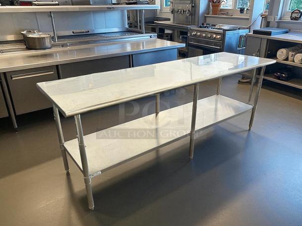 Uline H-10348 stainless steel worktable, like new, 96x30", adjustable height, bottom shelf, kitchen setting.