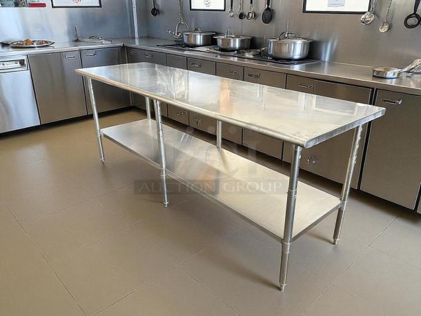 Uline H-10348 adjustable height stainless steel worktable, like new, 96x30", with bottom shelf, polished finish.