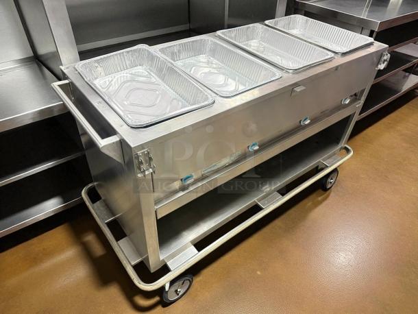 Duke E-4-DLSS 60" hot food table with four wells, cutting board, and 208v/1ph power. Tested, working, good condition.