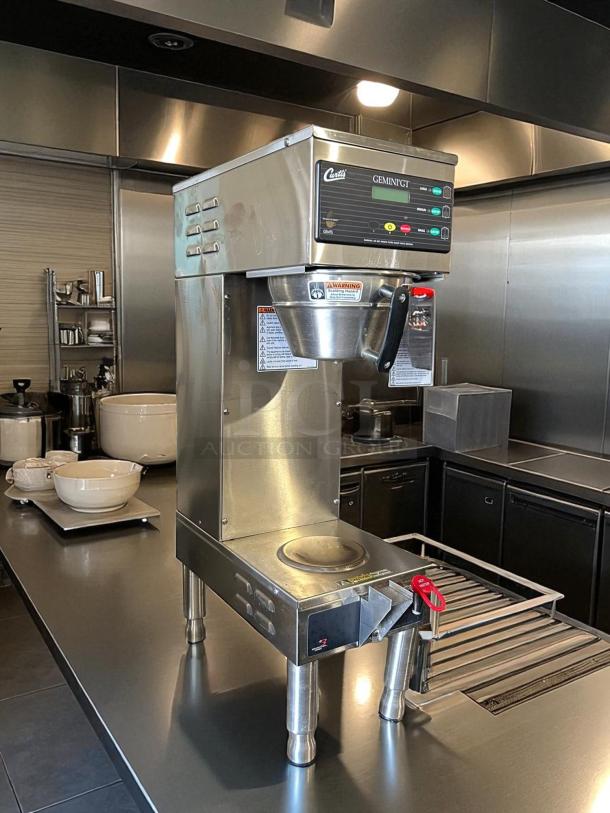 Curtis GEMSS63A1000 automatic coffee brewer in like-new condition with lower warmer and hot water faucet, fully tested.
