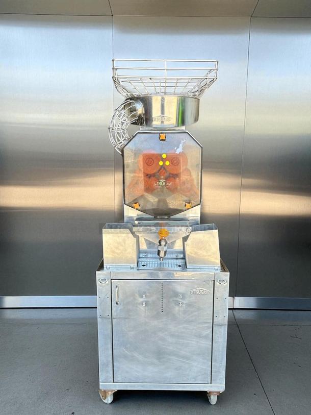 Citrocasa 8000SB commercial citrus juicer in excellent condition; 115V, fully tested. Stainless steel with protective casing.