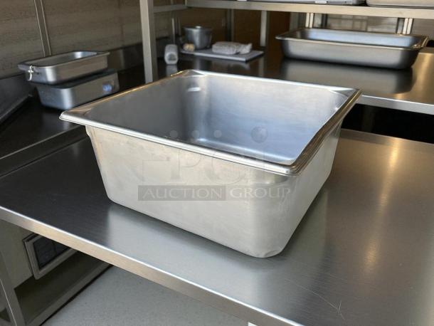 Heavy Duty 1/2 Size 6” Deep Stainless Steel Hotel Pan on metal table, excellent condition, sturdy gauge.