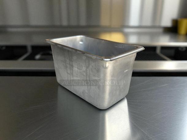 1/4 size 6” deep stainless steel hotel pan in excellent condition, showing minimal wear; ideal for catering use.