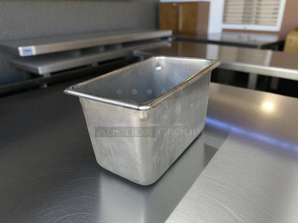 1/4 Size 6” Deep Stainless Steel Hotel Pan in excellent condition, shown on metal surface. Durable, kitchen essential.