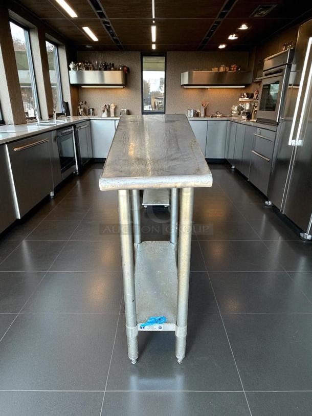 GSW stainless steel worktable in excellent condition, featuring robust legs. Label reads "DHL3." Ideal for durable workspace needs.