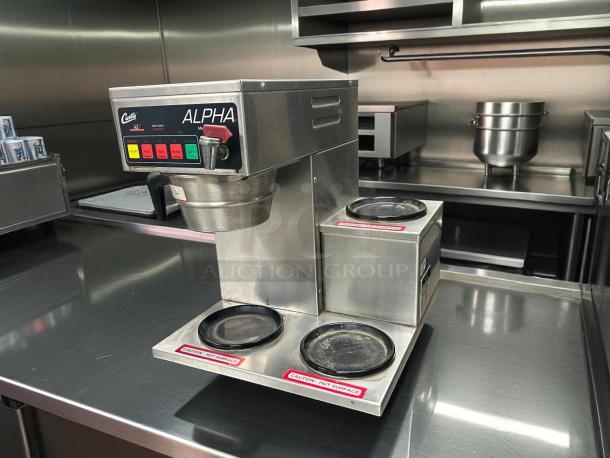Curtis ALPHA 3DR coffee brewer, excellent condition, 12 cup capacity, 3 lower warmers, 120V, fully tested and working.