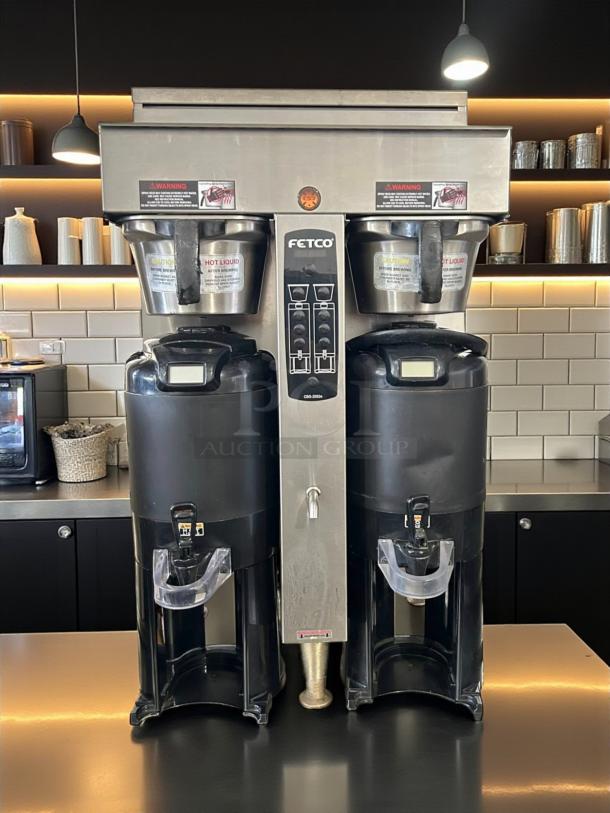 Fetco CBS-2052e Dual Station Coffee Brewer, excellent condition, 208-240V, fully tested, with caution labels visible.