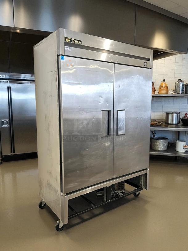 True T-49 54" reach-in refrigerator in great condition, stainless steel, two-section, 115V, fully tested, on casters.