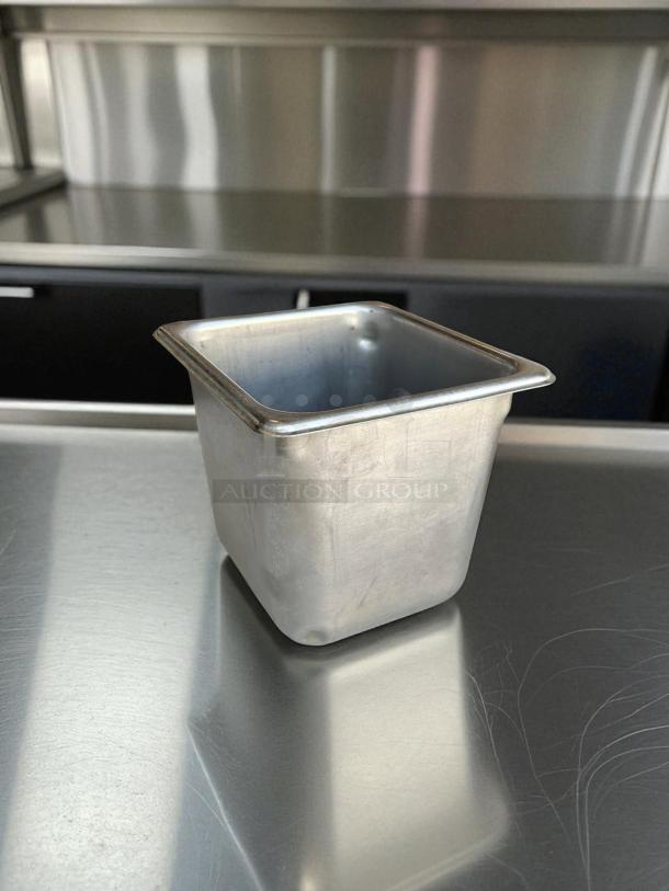 1/6 size, 6-inch deep stainless steel hotel pan, ideal for prep tables. Durable with no visible markings or tags.