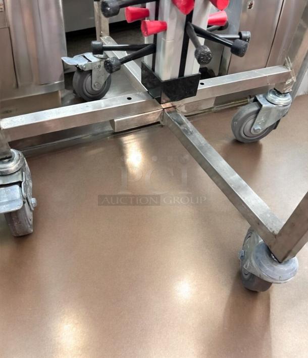 Stainless steel skewer/kebab rack with mobile holder, excellent condition, tested and working. Features sturdy wheels.