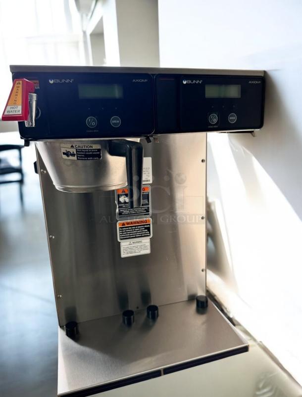 Bunn Axiom Twin APS coffee brewer, excellent condition, 120/208–240V, dual display, tested and working, warning labels visible.