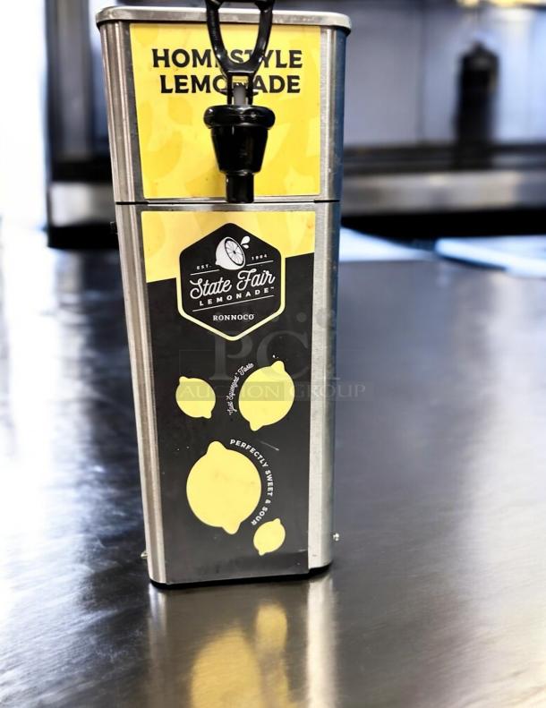 Newco FPM-1 State Fair Lemonade Dispenser in excellent condition, stainless steel, labeled "Homestyle Lemonade." Tested and working.