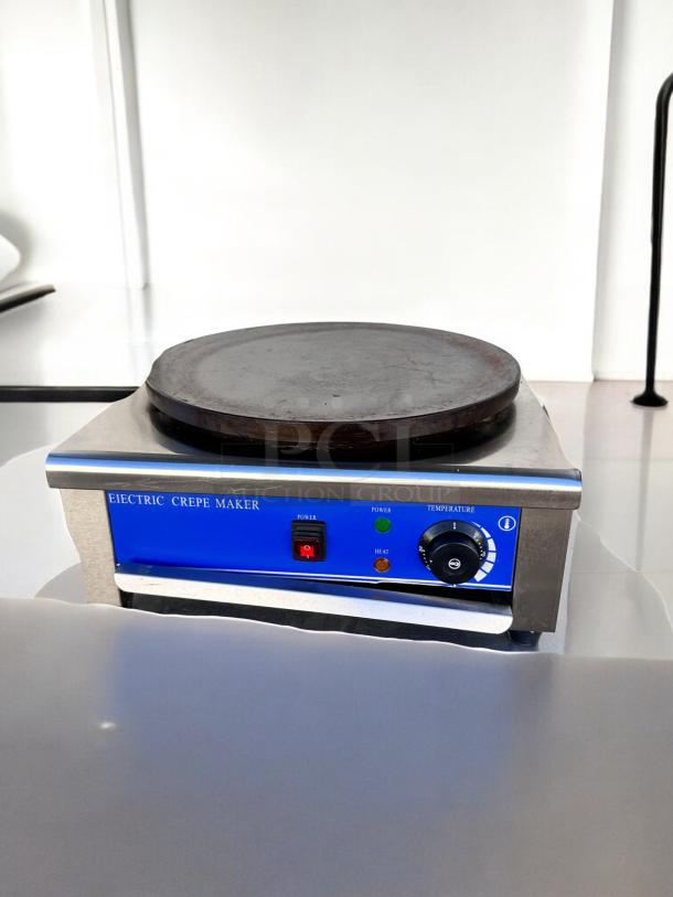Model Italy HE-1E electric crepe maker, 110V, 1500W, in excellent condition. Blue control panel with power and temperature knobs.