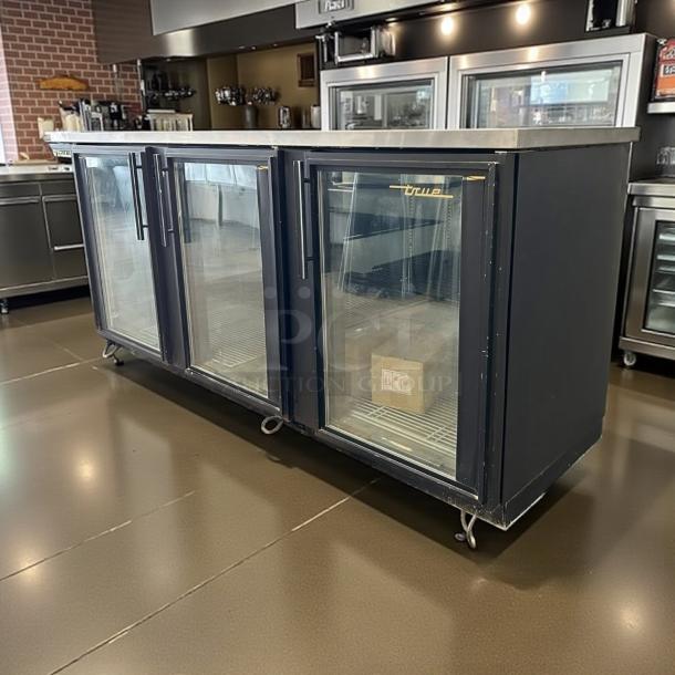 True TBB-4G-HC-LD 90" black glass door back bar refrigerator with LED lighting in excellent condition, fully tested.