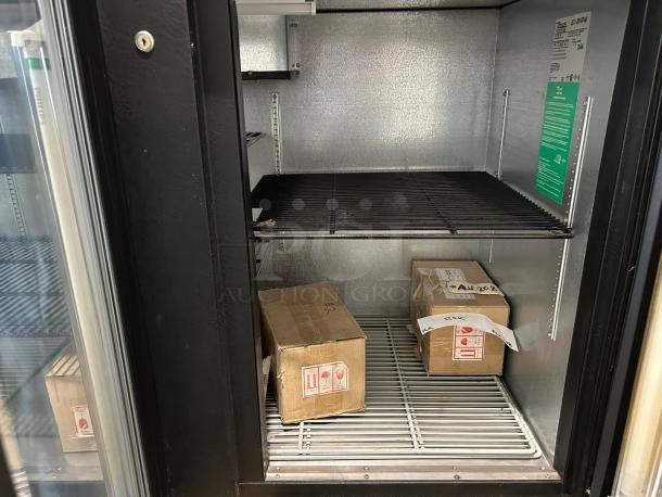 True TBB-4G back bar refrigerator with glass door, showing interior storage and packaging. Excellent condition with LED lighting.