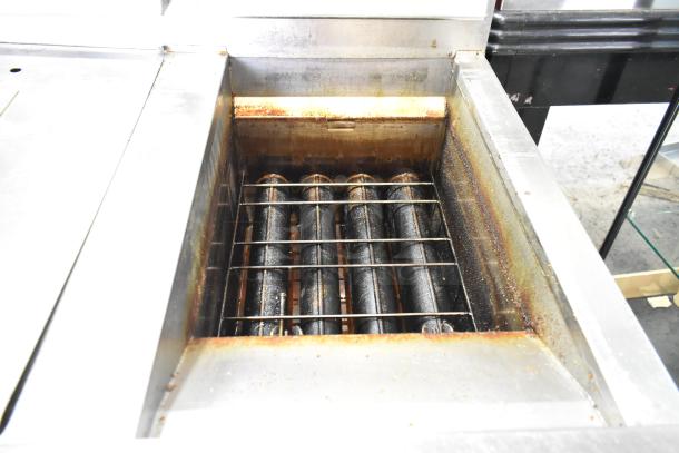 Henny Penny EEG-243 FFFX ST stainless steel 3-bay deep fryer, natural gas, 225,000 BTU, includes filtration system and lids.