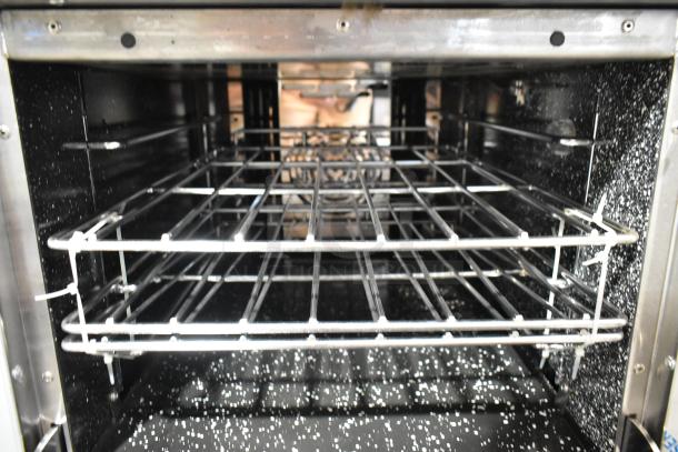 Inside of Venancio R602CO-60B commercial convection oven, stainless steel with racks visible, new condition.