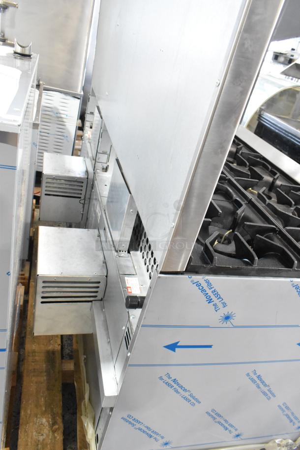 Brand new Venancio R602CO-60B stainless steel 10 burner range with 2 convection ovens, over shelf, and backsplash.