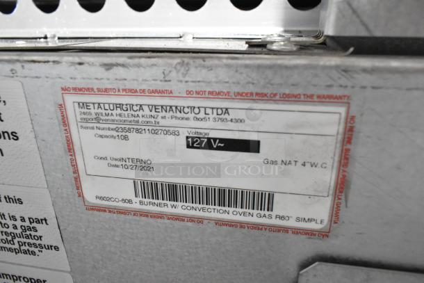 Label on Venancio R602CO-60B stainless steel gas range indicating model, serial number, and voltage.