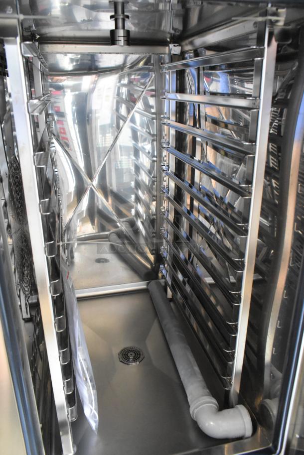 Bakers Pride AEHE101R stainless steel combi oven interior; shows racks and drainage system; brand new, scratch and dent.
