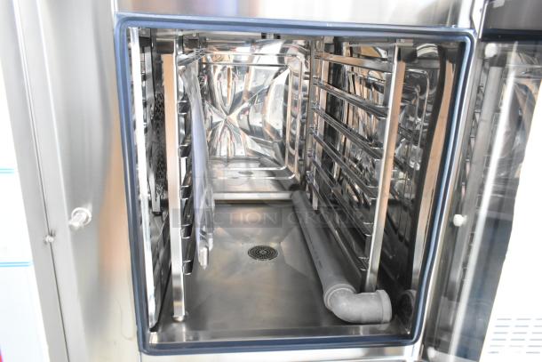 Brand new Blodgett ABTG061R stainless steel combi convection oven, natural gas powered, interior view showing racks and drainage.