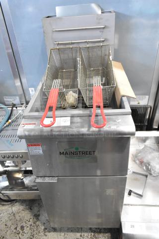 Stainless steel Mainstreet 541FF40L commercial fryer, 90,000 BTU, with 2 fry baskets. Brand new, slight dents. Tags visible.