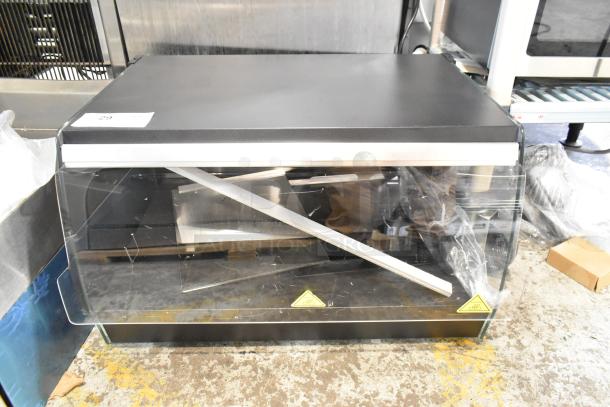 Brand new Avantco 177OAM1A 26" black countertop merchandiser with LED lighting, 1 shelf, and metal frame. Scratch and dent condition.