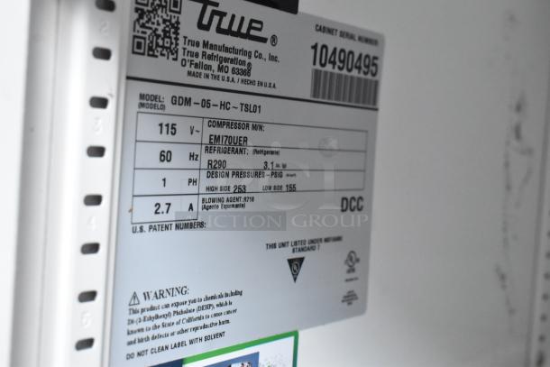Label on 2022 True GDM-05-HC mini cooler showing model details, 115V, R290 refrigerant, and warning information.