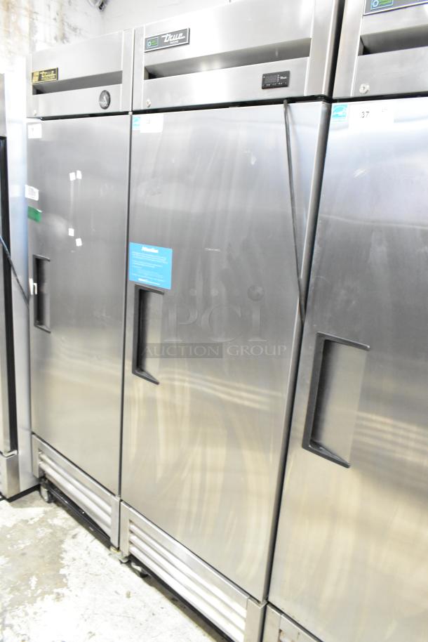 2020 True T-19F-HC stainless steel commercial single door freezer, features poly coated racks, commercial casters, 115V.