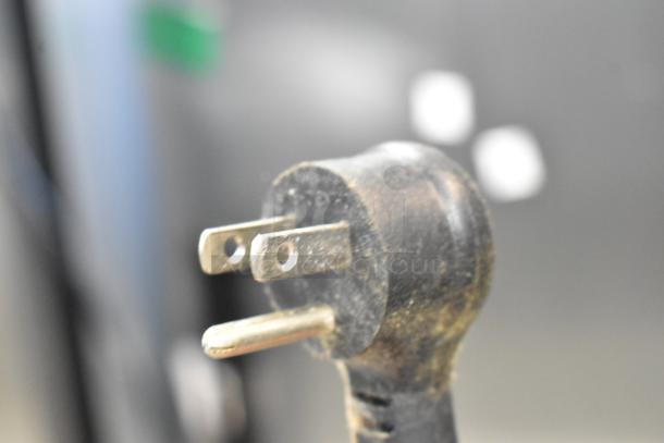 Close-up of a three-prong plug from a 2020 True T-19F-HC freezer, indicating 115 volts, 1 phase.