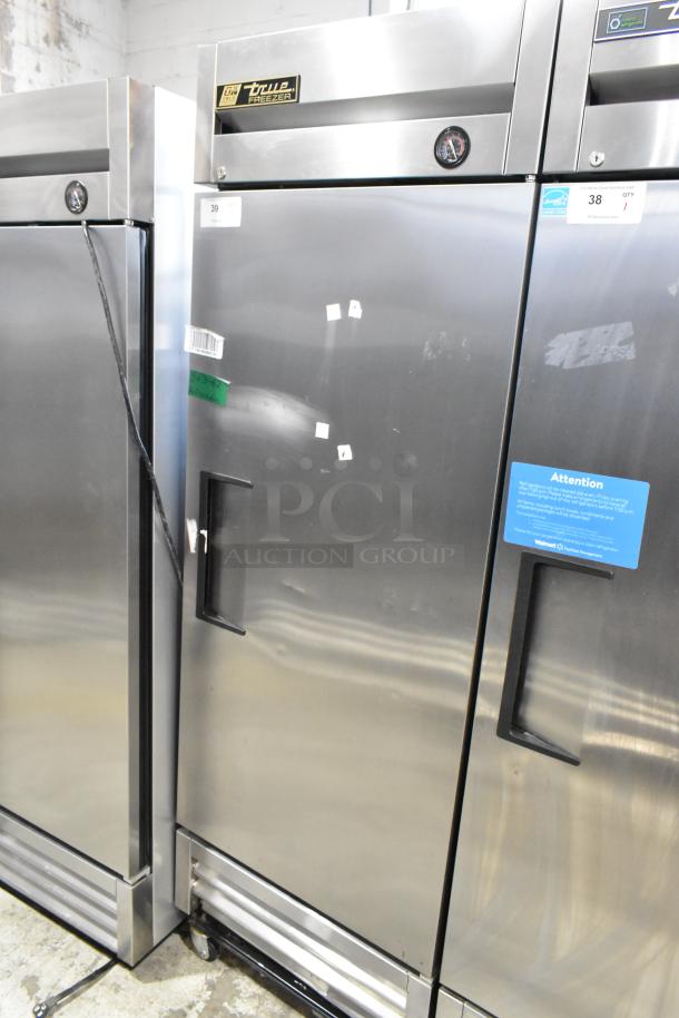 True T-19F stainless steel commercial single door reach-in freezer, on casters, 115 volts, 1 phase, visible use marks.