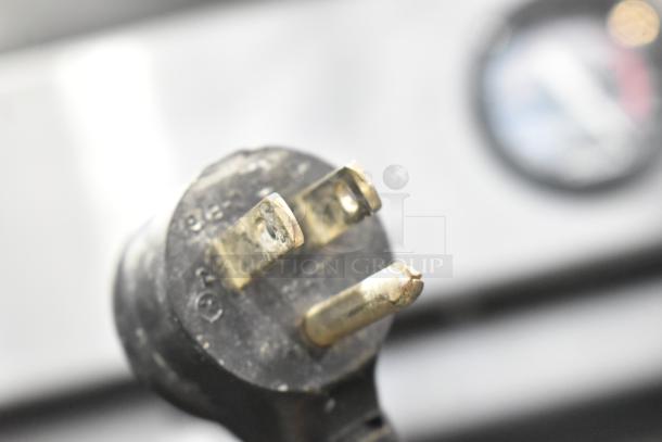Close-up of the plug for a 2016 True T-19F stainless steel commercial single door reach-in freezer.