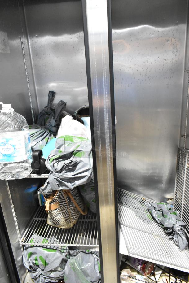 2016 True T-35 stainless steel 2-door reach-in cooler with poly-coated racks, 115 volts, 1 phase. Interior shows signs of use.