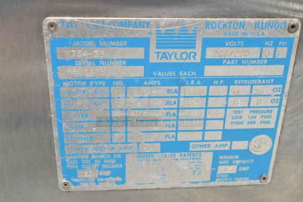 Taylor 754-33 stainless steel soft serve ice cream machine label showing model, serial number, and electrical specifications.