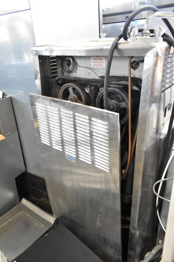 Taylor 754-33 stainless steel soft serve machine; commercial floor style, 2-flavor with twist. Visible mechanical components.