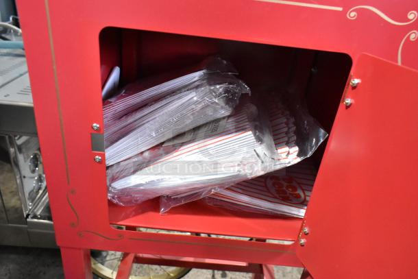 Nostalgia CCP510 metal vintage professional popcorn cart, 120 volts, red, storage compartment shown with popcorn bags.