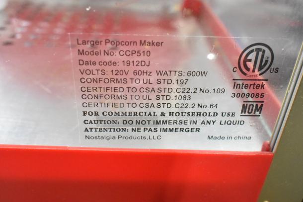 Nostalgia CCP510 metal popcorn cart label showing model, voltage, certifications, and safety instructions.