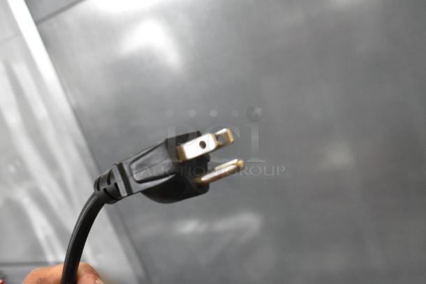 Close-up of a three-prong plug for the Nostalgia CCP510 Vintage Popcorn Cart, 120 Volts, 1 Phase power plug.