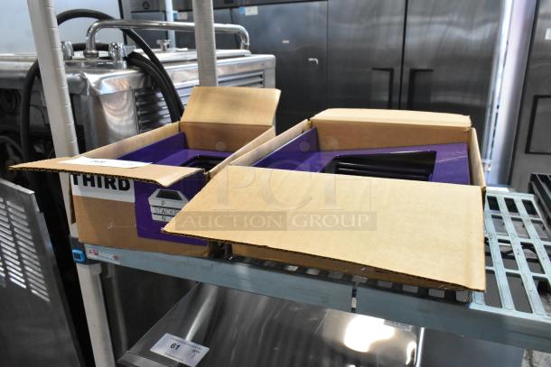 Two boxes of purple units on a metal rack; labeled as "STACKER." Boxes are open, revealing the contents.