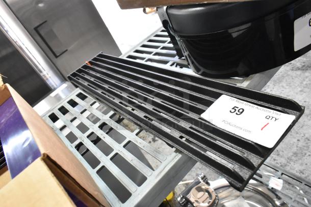 Cast iron charbroiler grate, black with ridged surface, in good condition. Auction label indicates item number 59.