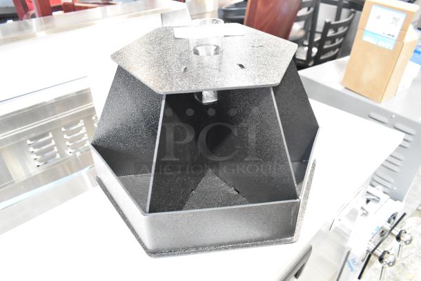 Brand new black poly holder, hexagonal shape, visible scratch and dent, sturdy construction, no visible brand markings.