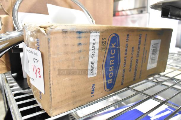 Bobrick 540MBLK Multi-Roll Tissue Dispenser, matte black, new in box, model label visible, scratch and dent condition.