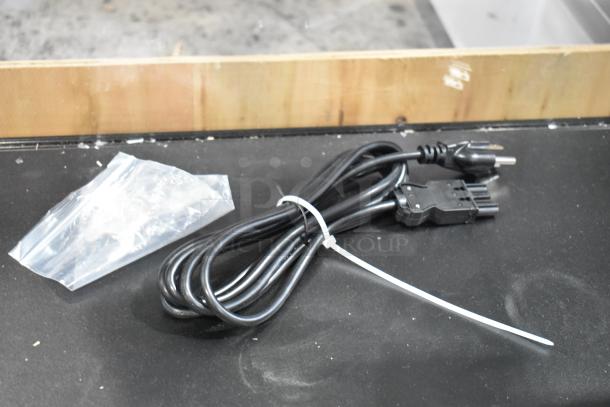 Alt Text: Dry Merchandising Display Case with power cord, transparent bag, wooden frame background, in good condition.