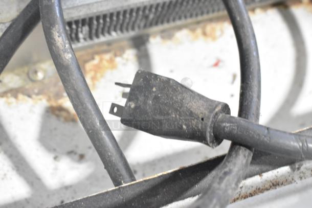Close-up of the power cord and plug of Federal Industries SN6CD-2 display case merchandiser; shows signs of wear.