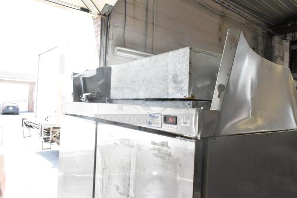Hobart stainless steel commercial 2-door reach-in cooler, 115 volts, 1 phase. Features visible wear, ideal for frozen storage.