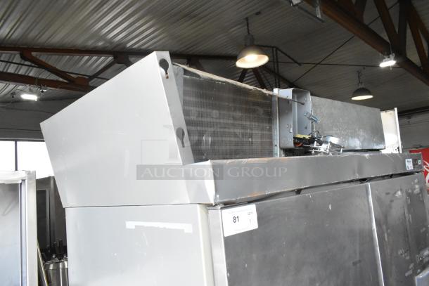 Hobart stainless steel commercial 2-door reach-in cooler, 115 volts, 1 phase, visible markings of wear, auction label attached.