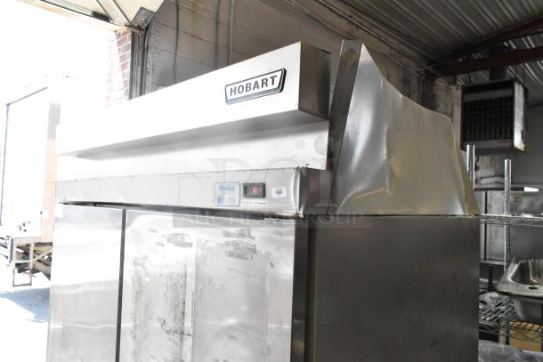 Hobart Stainless Steel Commercial 2 Door Reach-In Cooler, 115 Volts, 1 Phase. Signs of wear on the exterior.