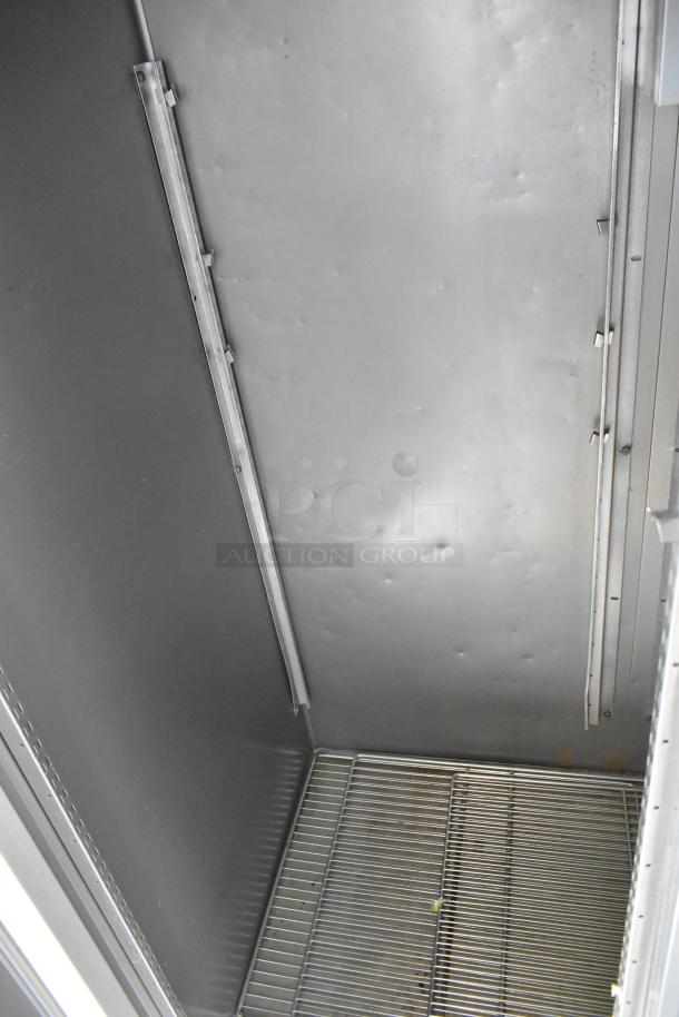 Hobart stainless steel commercial 2-door reach-in cooler interior, showing shelves and stainless steel walls. 115 volts, 1 phase.